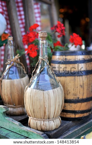 Rustic still life with bottle of wine and small barrel