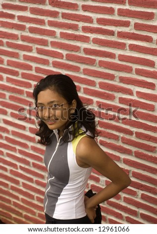 Athletic asian lady with brick wall background