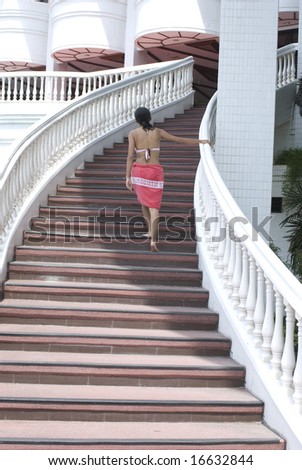 Girl in swimsuit climbing steps