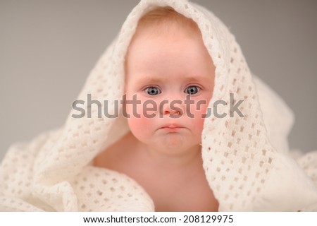 baby girl is hiding under the white blanket with different emotions