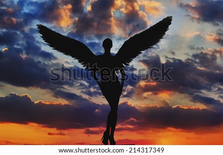 angel with white wings in the dramatic sky