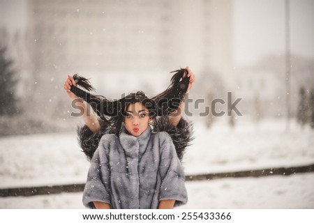 funny girls enjoying winter weather  - with film effect with small grain