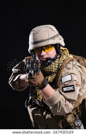 army girl with gun isolated over black background