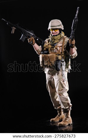 army girl with gun isolated over black background