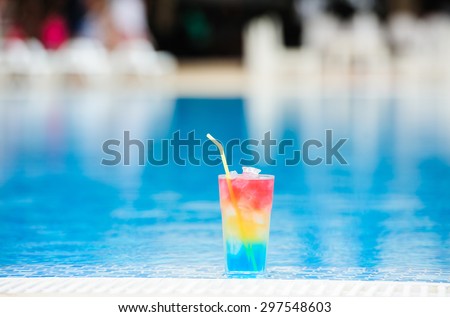 cocktail near the swimming pool with blue water