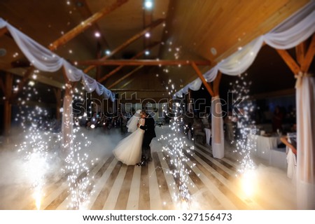 bride and groom dancing on the own wedding with white fume