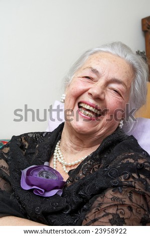 Smiling grandmother with silk violet rose