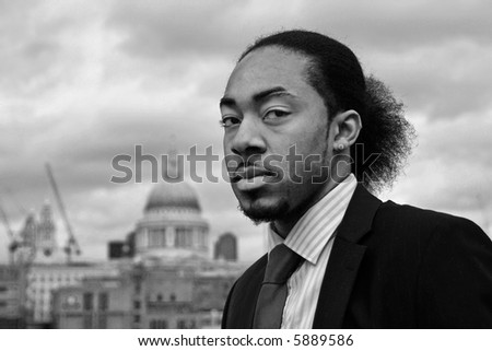 A young black man with the City of London in the background.