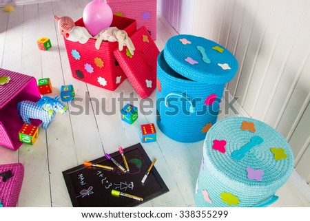 Wicker basket of colored storage and toys