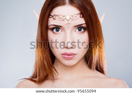 Girl elf with a tiara on her head and looked wistfully looking at the viewer