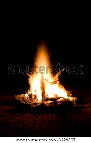 Small campfire built outdoors for people to sit around