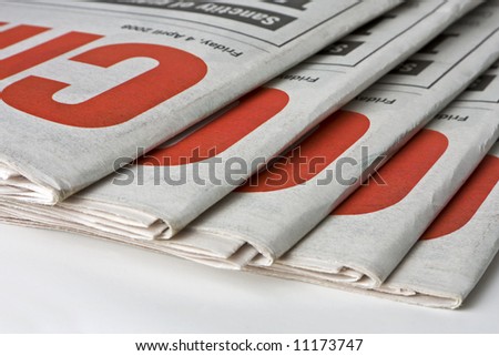 Duplicate copies of a daily newspaper. Can be used as conceptual or to indicate print media.