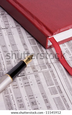 A diary and a fountain pen placed on a financial newspaper. Perfect for use in financial scenarios or business topics.
