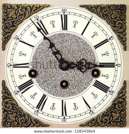 Closeup of an old table clock with decorations, vintage style