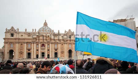 ROME, ITALY - MARCH 17: The crowd is waiting in St. Peter Square before the first Angelus prayer of Pope Francis I, A flag of Argentina in foreground, on March 17, 2013 in Vatican City, Rome, Italy