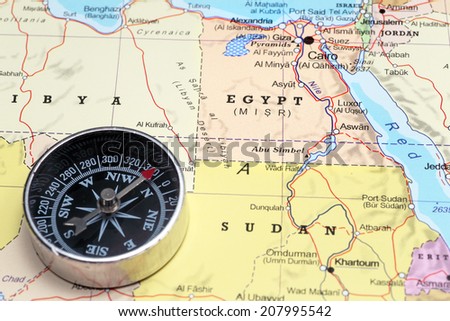 Compass on a map pointing at Egypt, planning a travel destination