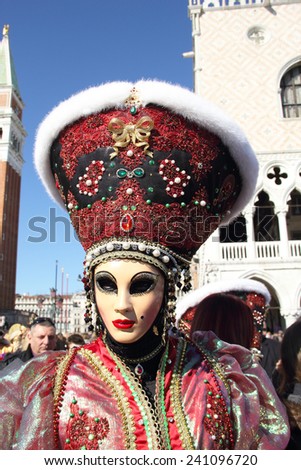 VENICE, ITALY - February 23: An unidentified masked woman with a flashy hat in St. Mark Square during the traditional festival of Carnival on February 23, 2014 in Venice, Italy