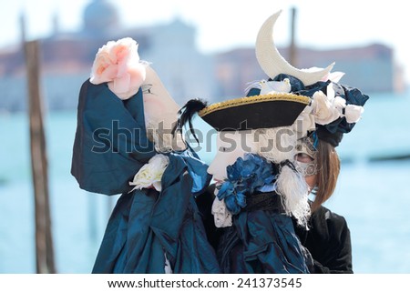 VENICE, ITALY - February 23: An unidentified woman plays her two puppets in front of the Church of San Giorgio Maggiore during the Carnival on February 23, 2014 in Venice, Italy