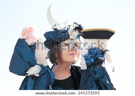VENICE, ITALY - February 23: An unidentified masked woman plays her two puppets during the traditional festival of Carnival on February 23, 2014 in Venice, Italy