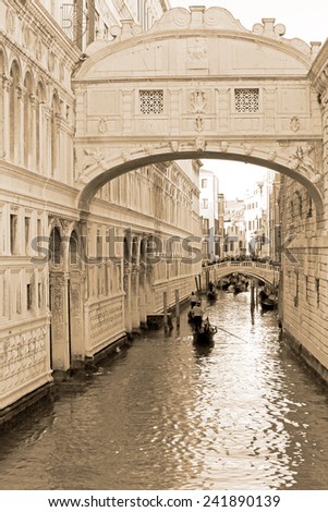 VENICE, ITALY - February 23: Gondolas carry tourist through the canals of Venice on February 23, 2014 in Venice, Italy. Photography in sepia tone