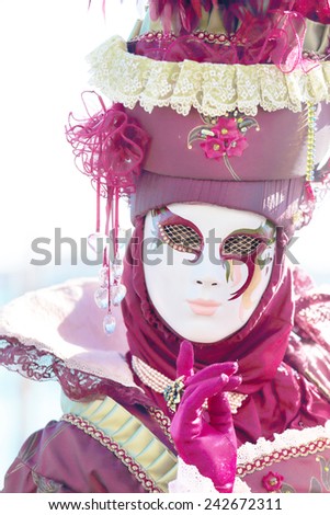 VENICE, ITALY - February 23: A red masked lady exhibited during the traditional festival of Carnival on February 23, 2014 in Venice, Italy