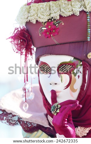 VENICE, ITALY - February 23: A masked lady hushing exhibited during the traditional festival of Carnival on February 23, 2014 in Venice, Italy
