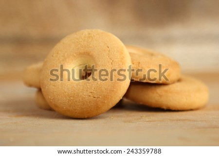 Closeup of a pile of round cookies on a wooden background