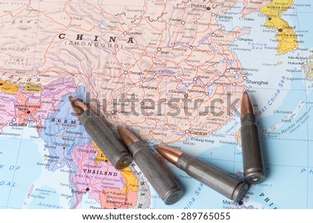 Four bullets on the geographical map of China. Conceptual image for war, conflict, violence.