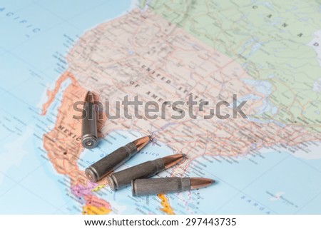Four bullets on the geographical map of United States of America. Conceptual image for war, conflict, violence.