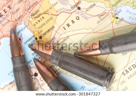 Four bullets on the geographical map of Iraq and Syria in Middle East. Conceptual image for war, conflict, violence.