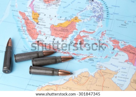 Four bullets on the geographical map of Indonesia. Conceptual image for war, conflict, violence.