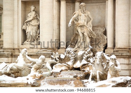 The statues of Trevi Fountain covered by snow, a really rare event in Rome