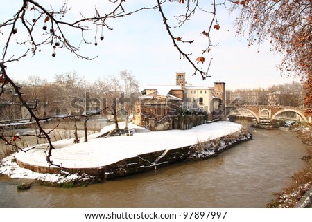 The Tiber island in the middle of Rome covered by snow, a really rare event in the City