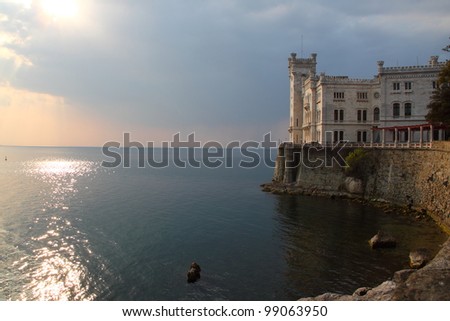 Miramare Castle at sunset in Trieste Italy, a white castle overhanging the sea