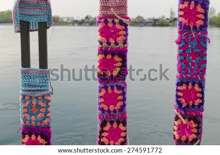 Knitted ornaments on a metal fence on Angara river embankment. Irkutsk