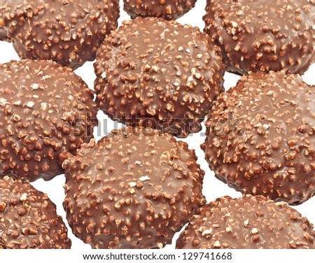 Cookies covered with chocolate and nuts close up isolated