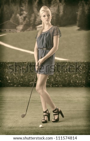 beautiful blonde girl in full lenght plays golf with blue short dress and hig shoes, vintage color shot