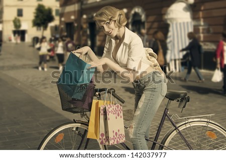 sensual blonde shopping woman win old fashion contest going for shop with bicycle with vintage color