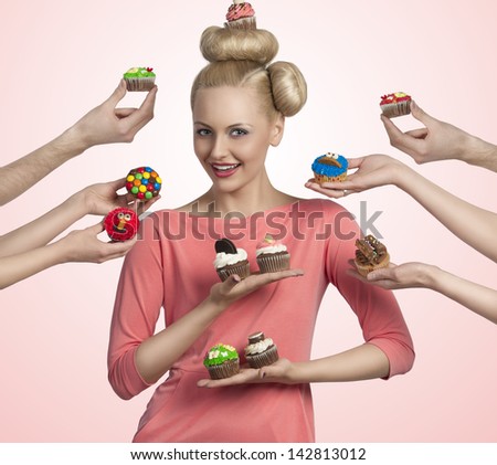 pretty blonde girl with colored make-up and funny hair-style taking cupcakes. Some hands tendering other colorful cupcakes