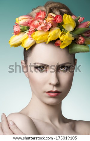 close-up portrait of beauty woman with pure skin, cute make-up and colorful floral garland on the head. Spring atmosphere