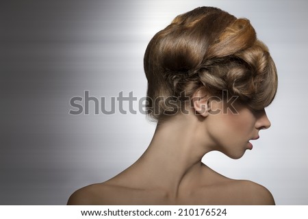 beauty shoot of sexy girl with elegant creative hair-style, her visage is turned on right