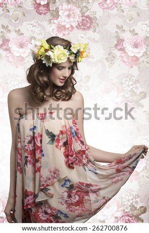 sensual young brunette girl posing with spring style, floral crown and dress, romantic atmosphere, natural make-up and hair-style
