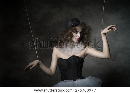 uncombed sensual woman with gothic puppet costume, uncombed hair and clown make-up. She wearing vintage tutu and bowler