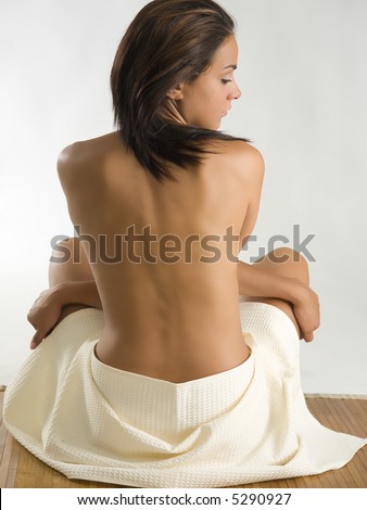 very beautiful girl sitting down and showing her sensual naked back