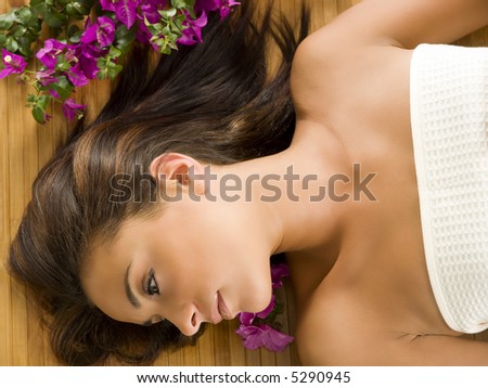portrait of a beautiful brunette laying down on a wood carpet