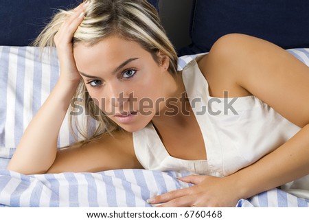 young blond girl on her bed one morning just waked up