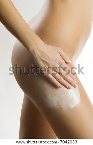 stock photo cute and naked girl spread cream on her leg