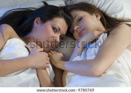 two sweet girls in bed face to face as close friends