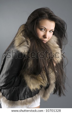 pretty girl with fur jacket in the wind looking cold