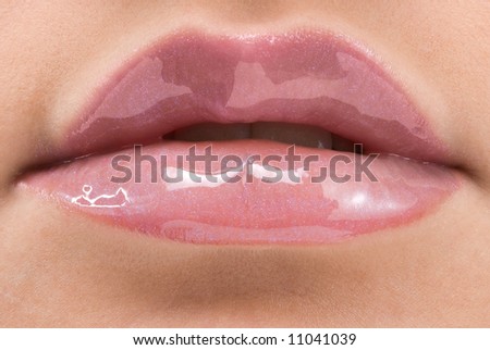 close up of a red mouth with lipstick and lip gloss